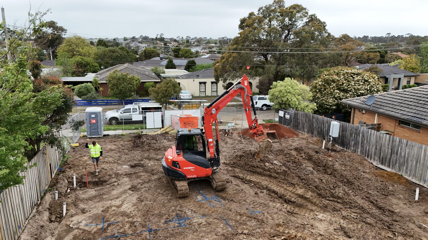 Mini excavator working on a narrow residential block.